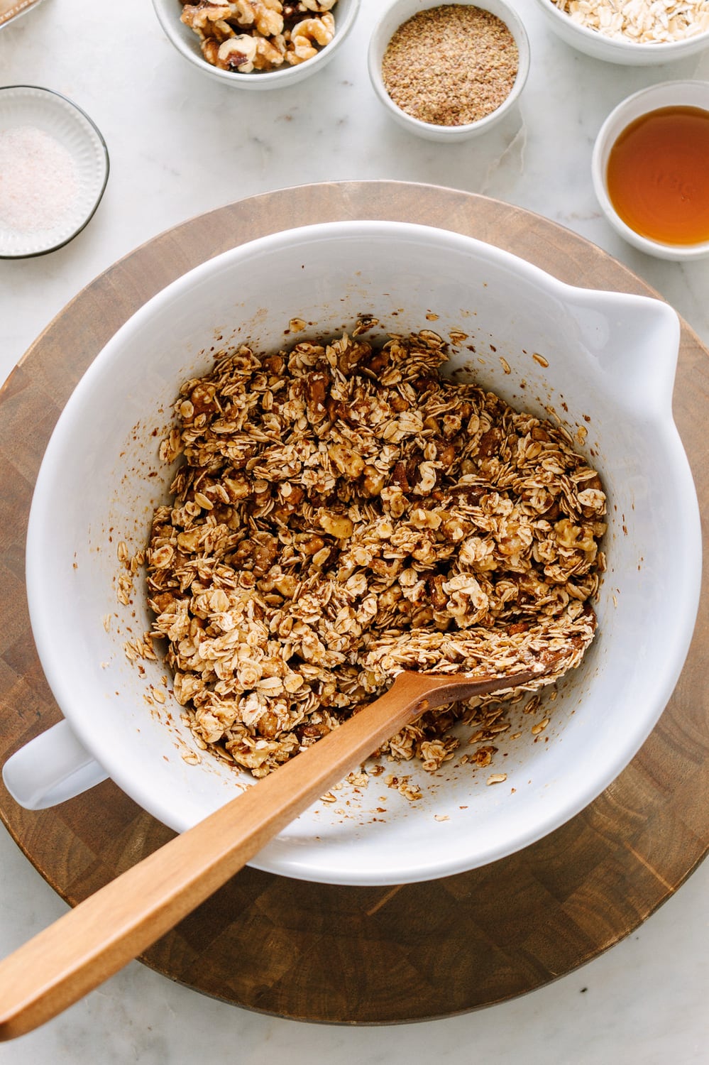 APPLE & CRANBERRY CRISP: making the crumbly oat topping in a large white mixing bowl with ingredients on hand