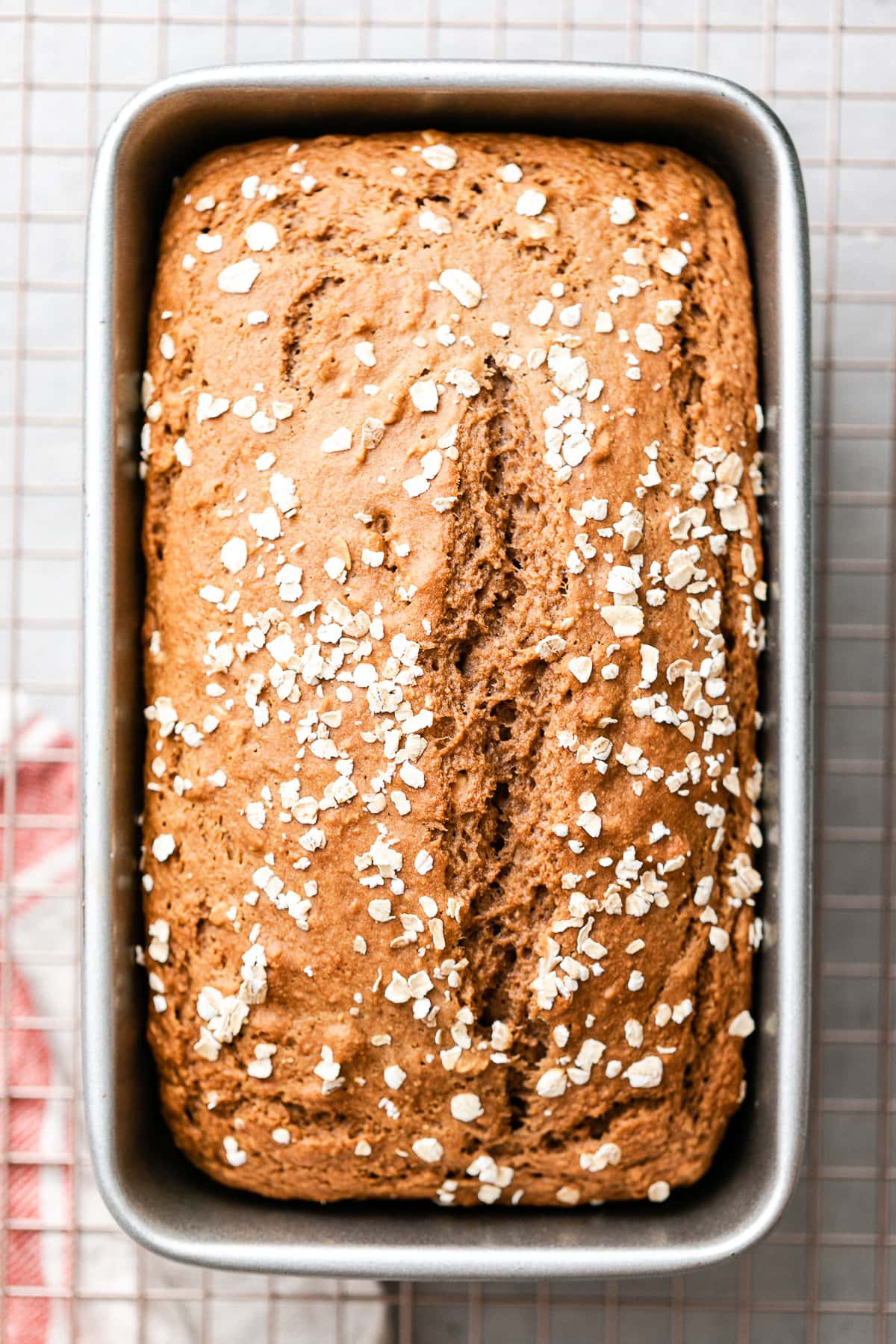 top down view of freshly baked applesauce bread in a loaf pan.