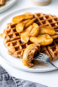 side angle view of cinnamon applesauce waffles with fork.