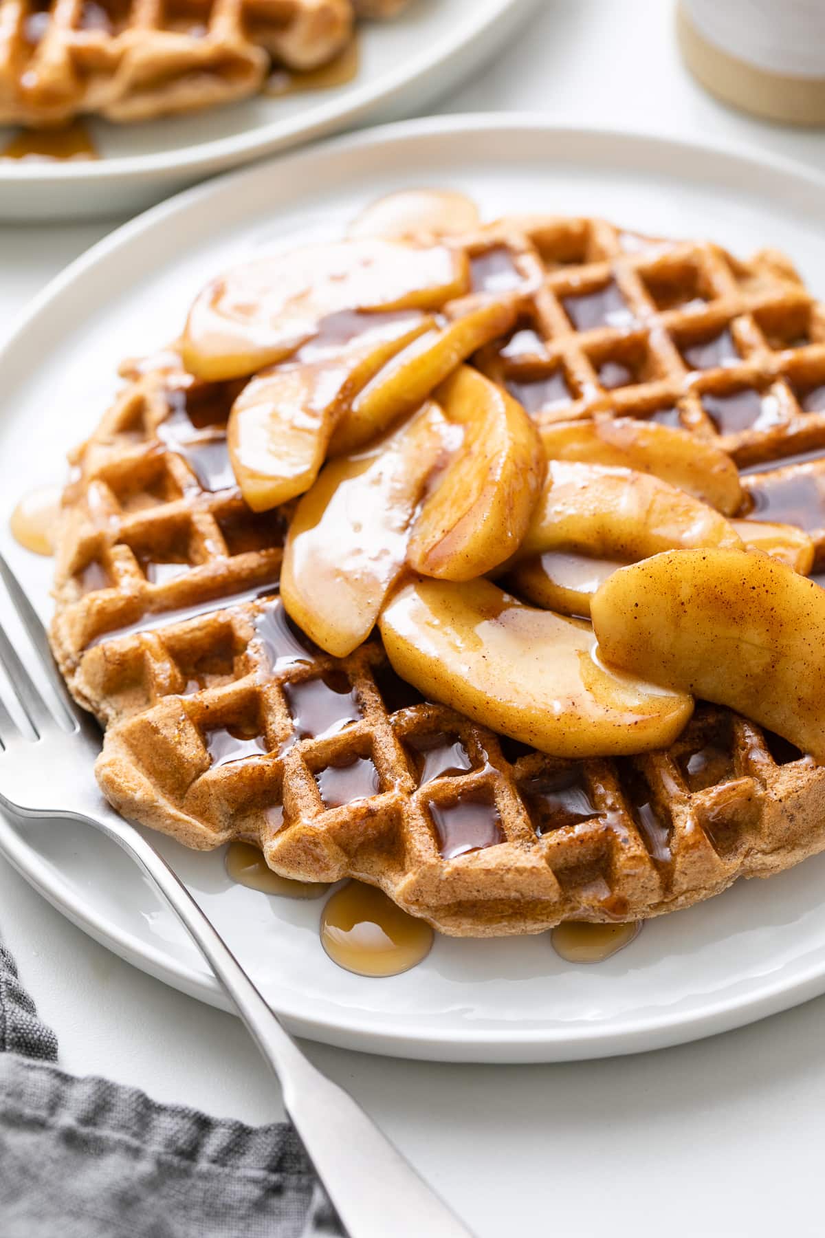 side angle view of plated cinnamon applesauce waffles.