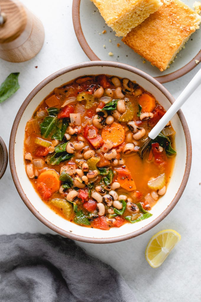 top down view healthy black eyed pea soup in a bowl with spoon.