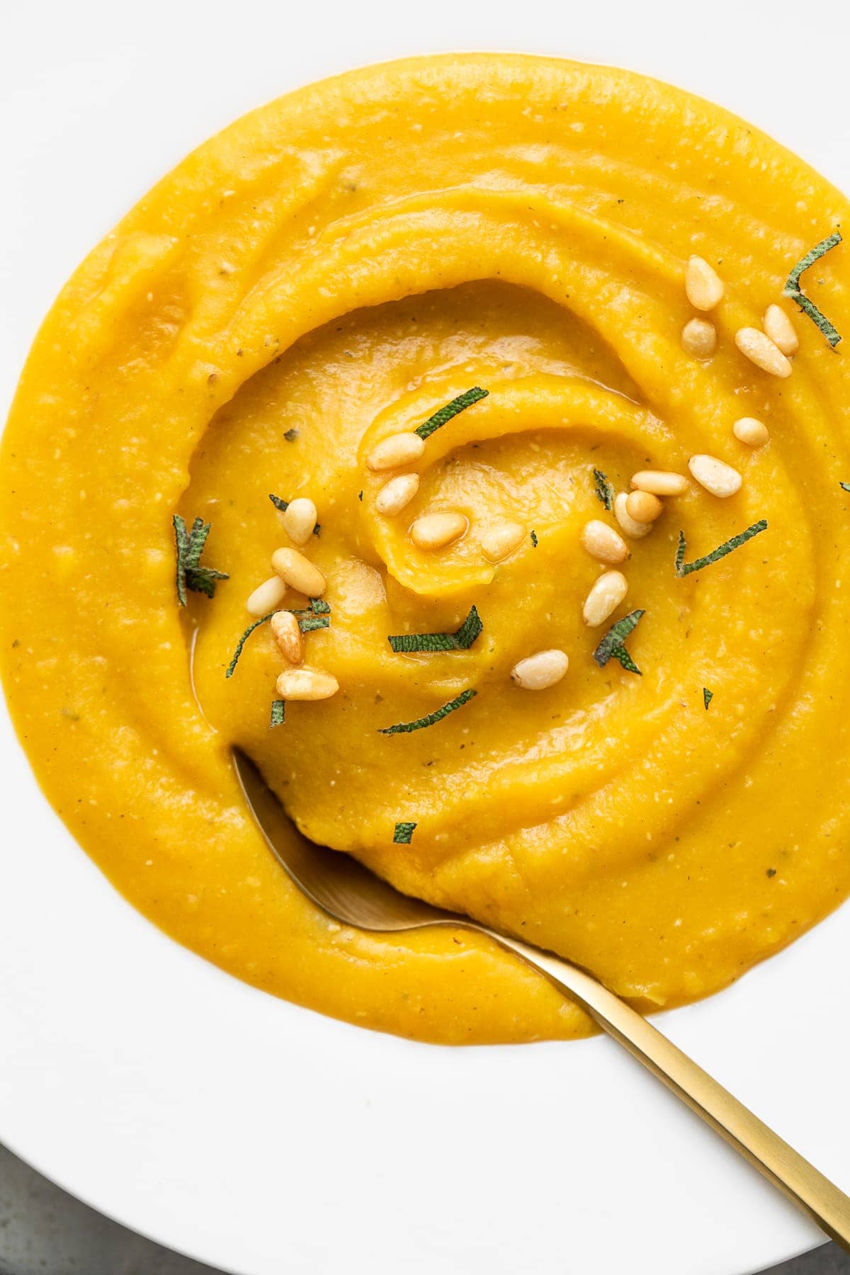 up close view of bowl with serving of healthy butternut squash red lentil soup.