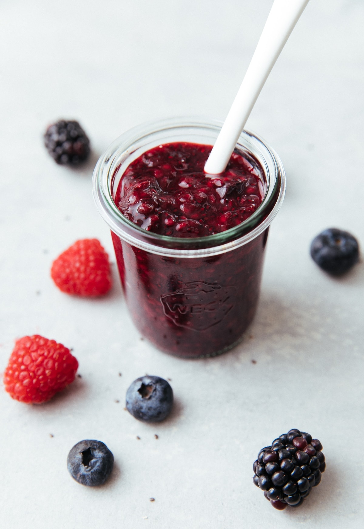 side angle view of glass jar with berry chia seed jam.