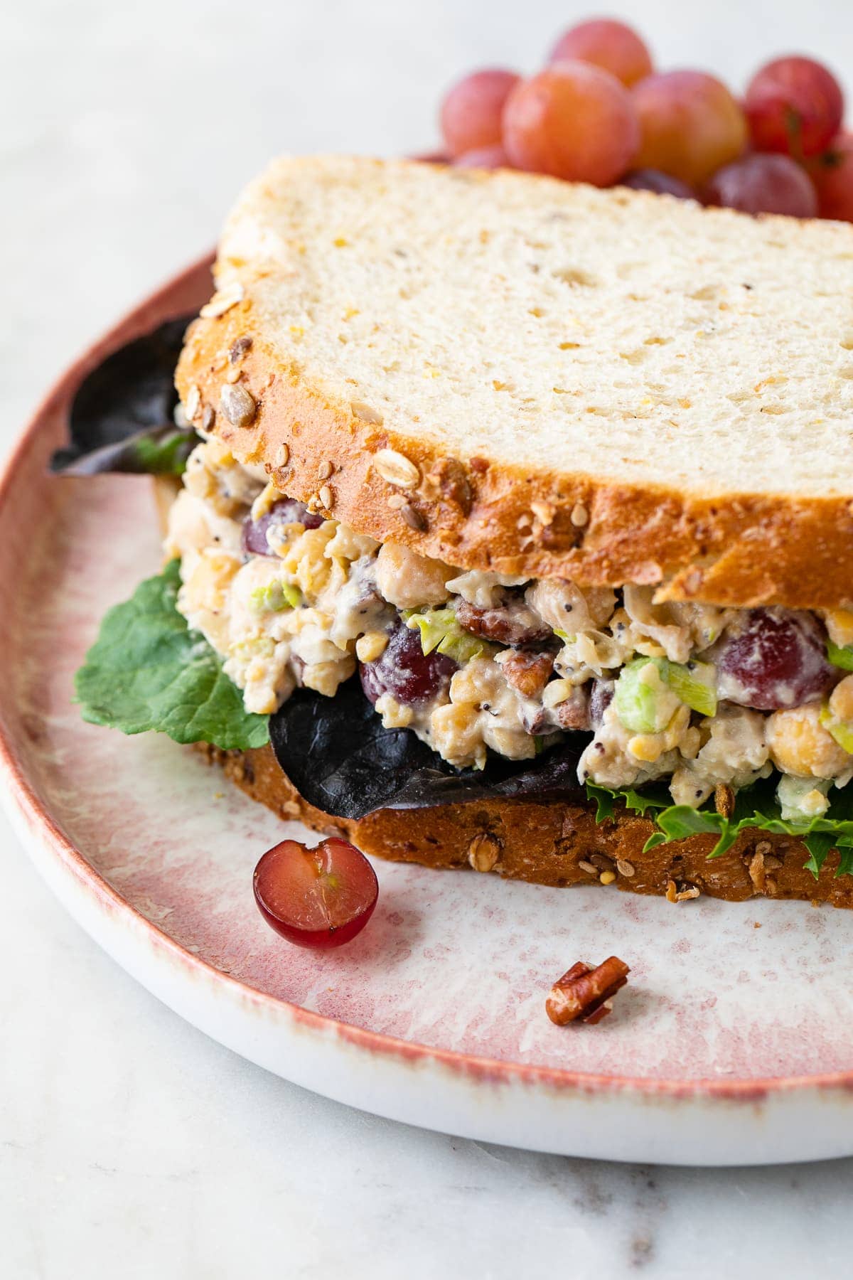 side angle view of Sonoma chickpea chicken sandwich on a plate.