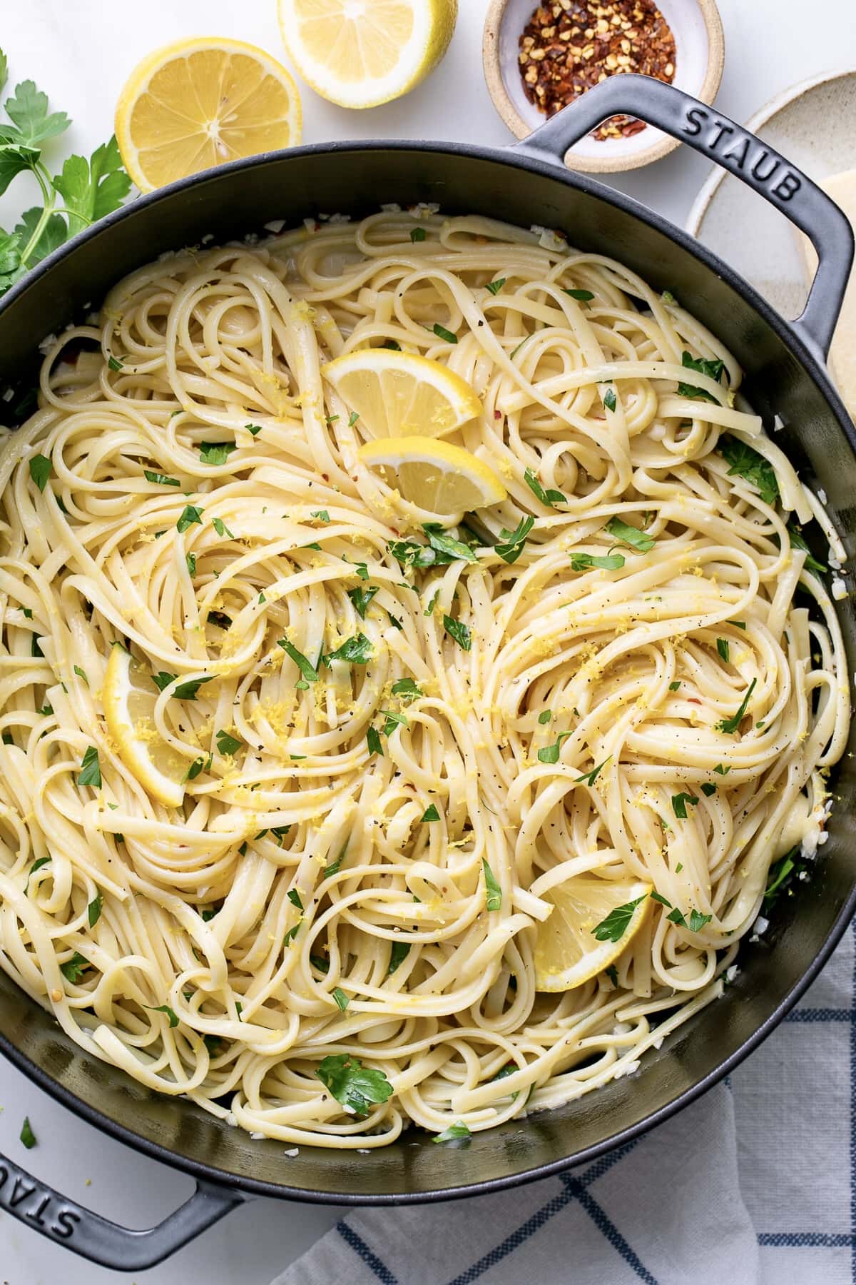 top down view of simple lemon pasta in a pot with items surrounding.