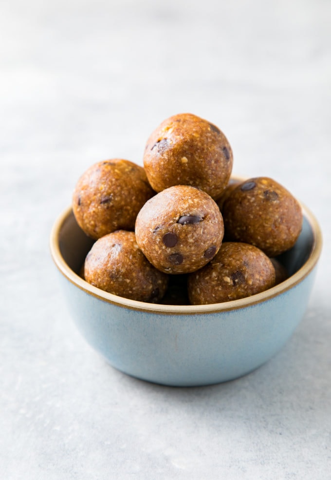 side angle view of chocolate chip energy bites in a small bowl.