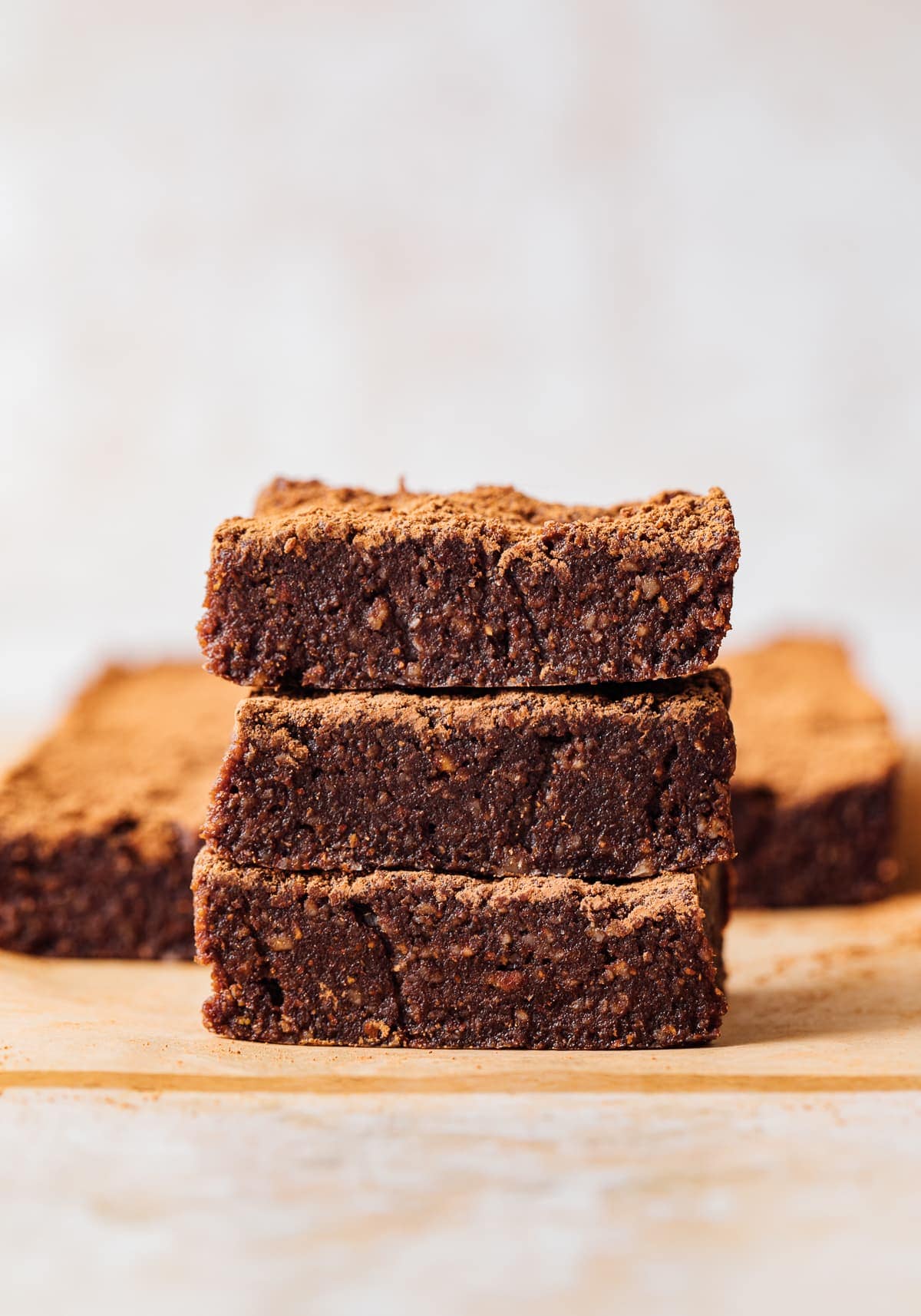 head on view of 3 stacked raw vegan brownies.