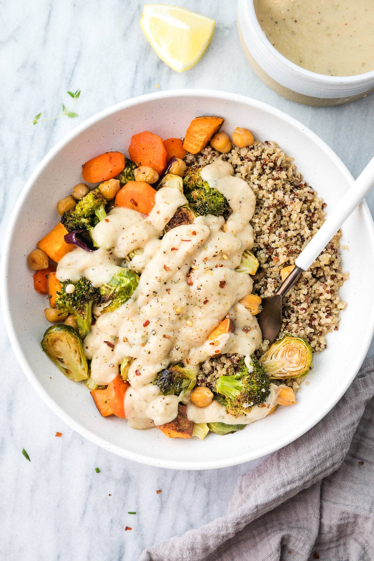 top down view of roasted veggie bowl with white bean sauce in a bowl.