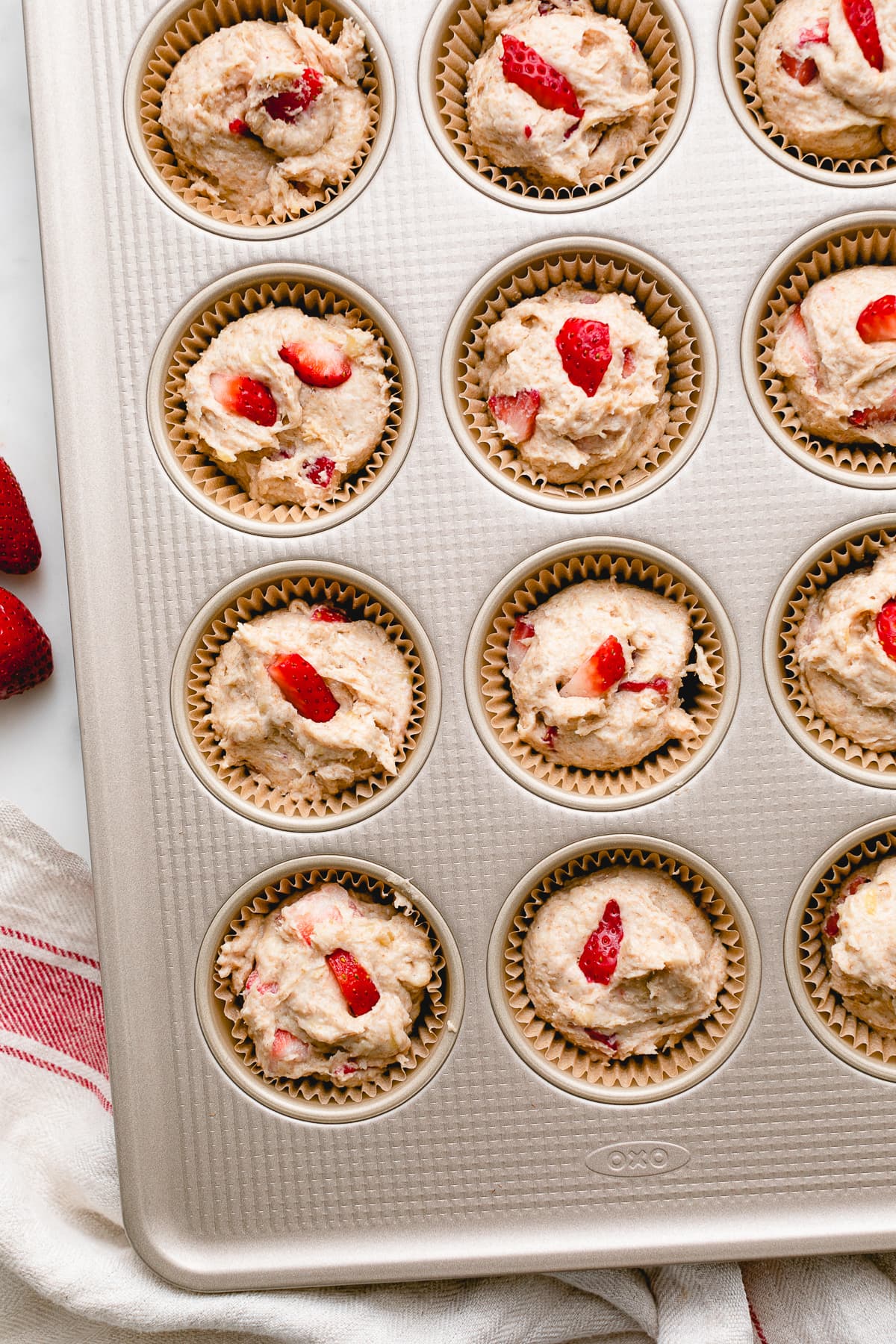 top down view of vegan strawberry banana muffin batter in muffin tin.