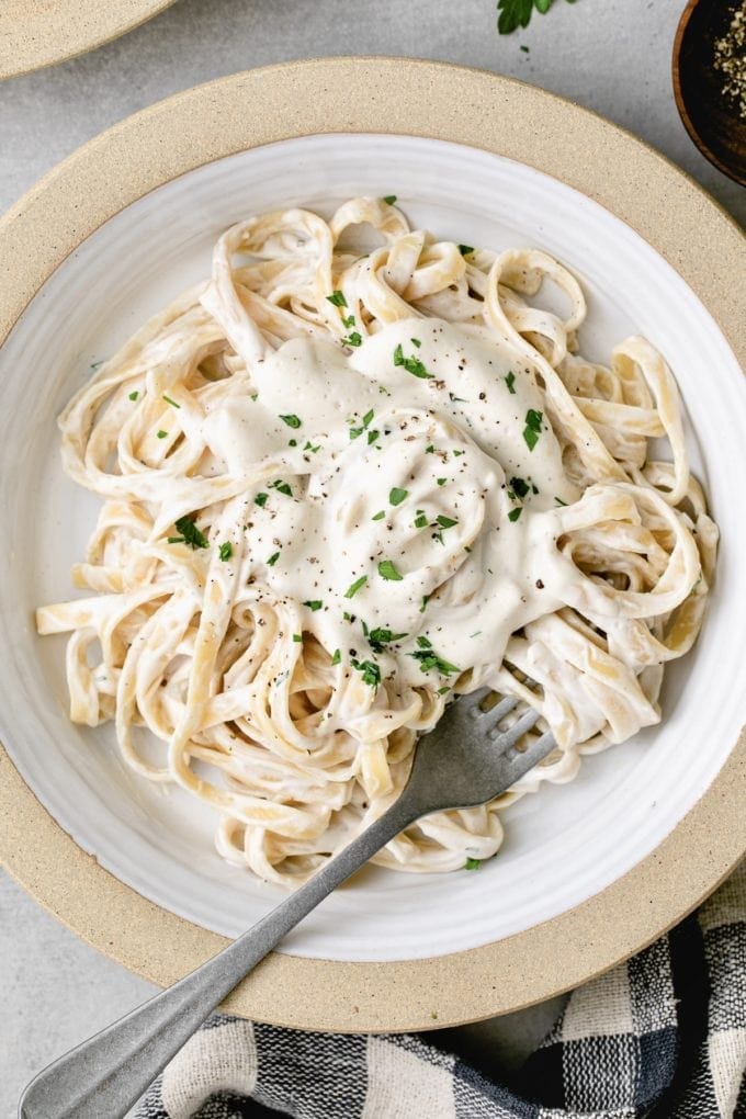 top down view of plated vegan alfredo sauce with pasta.