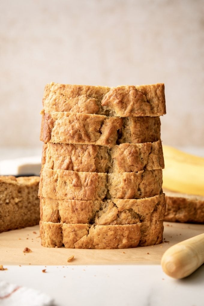 head on view of sliced vegan banana bread stacked on top of each other.