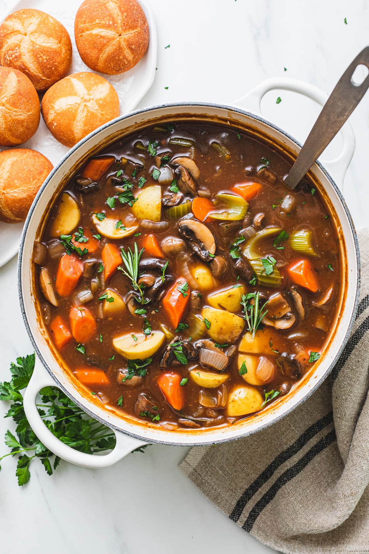 top down view of freshly made pot of vegan Irish stew with items surrounding.