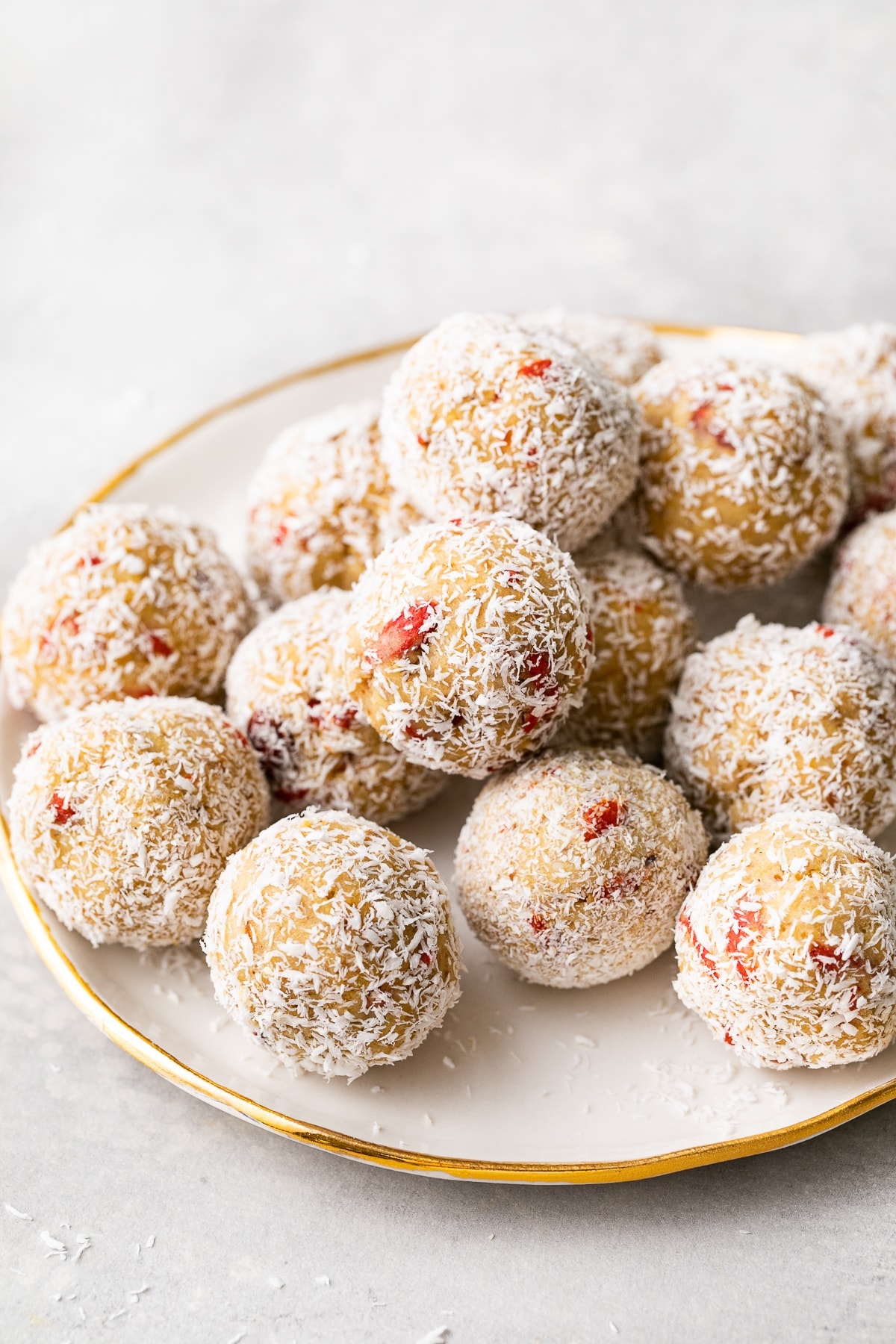 side angle view of vegan white chocolate truffles on a plate.