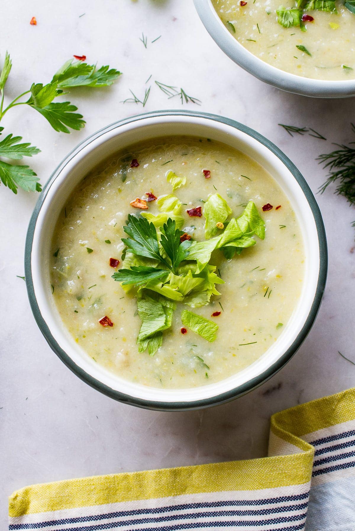 top down view of a bowl with a serving of healthy celery soup.