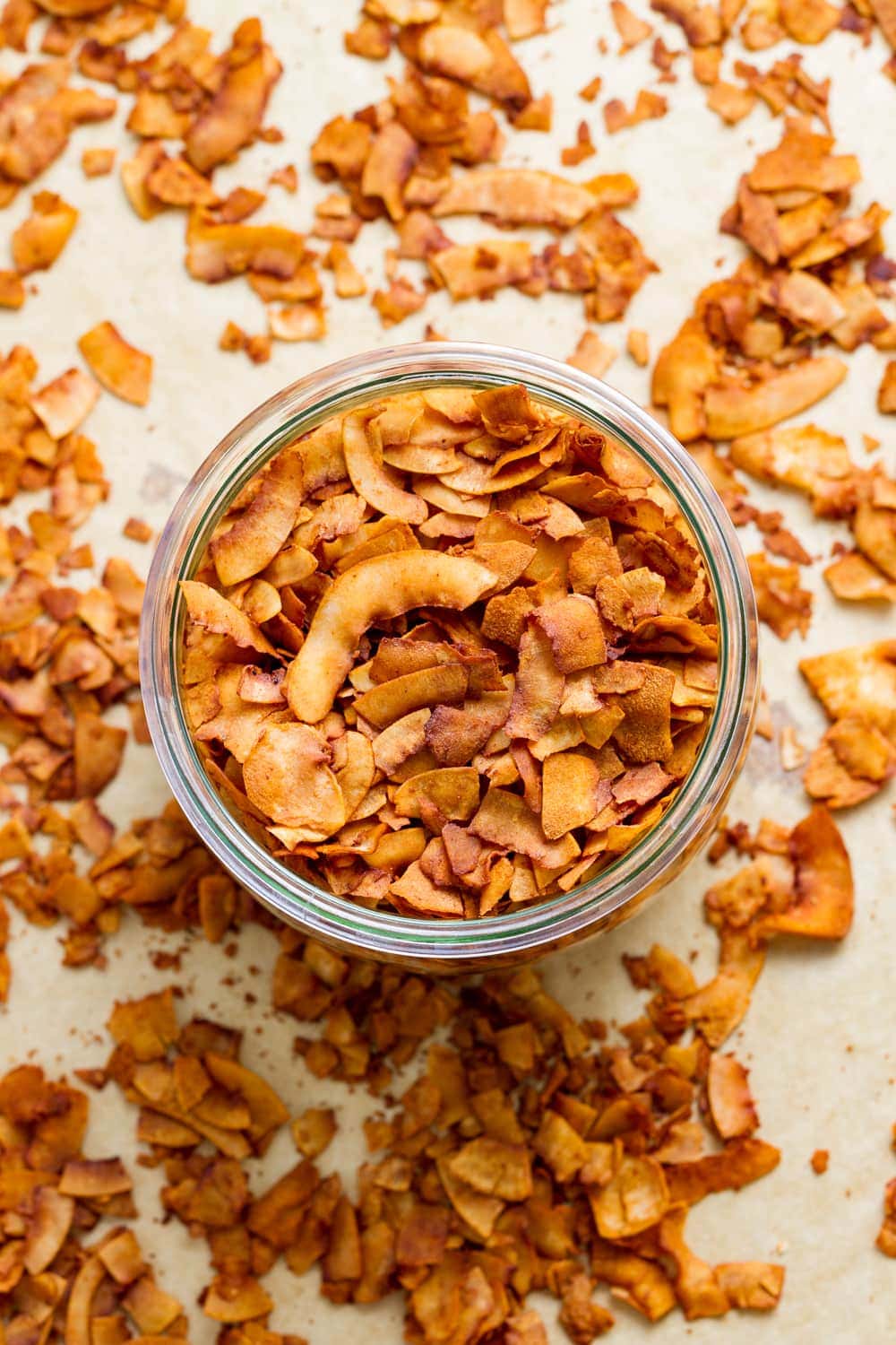 top down view of freshly made coconut bacon in a glass mason jar.