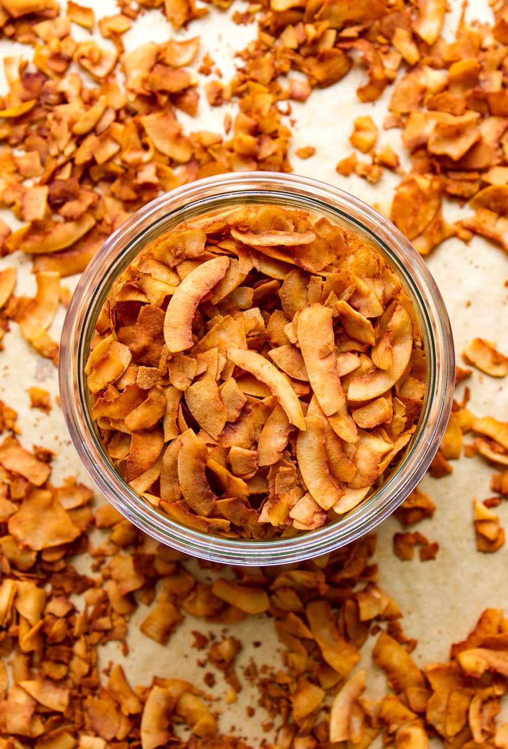 top down view of freshly made coconut bacon in a glass mason jar.