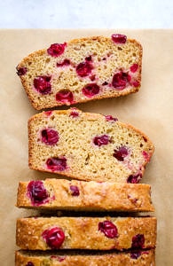 sliced orange cranberry bread on parchment paper