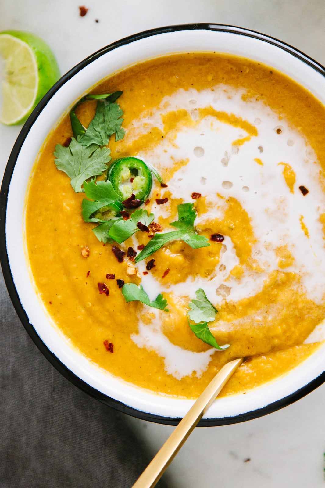 top down view of bowl of curry sweet potato and red lentil soup.