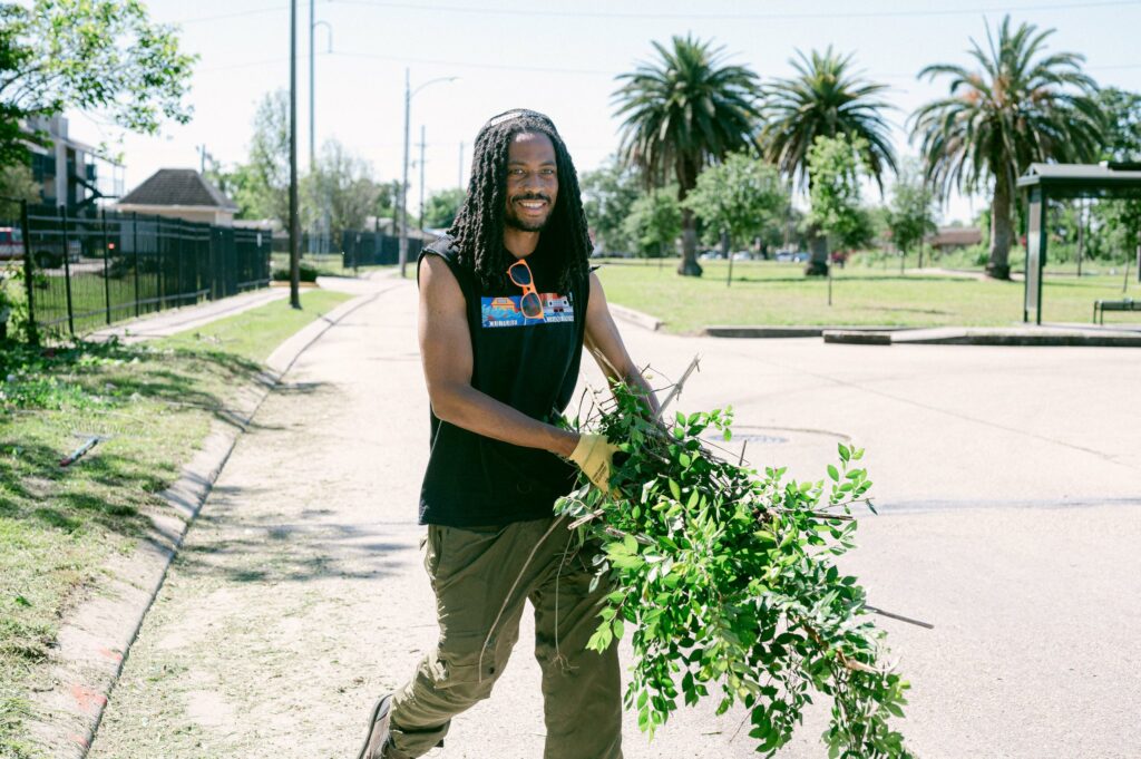 Gregory Swafford smiling while holding leaves