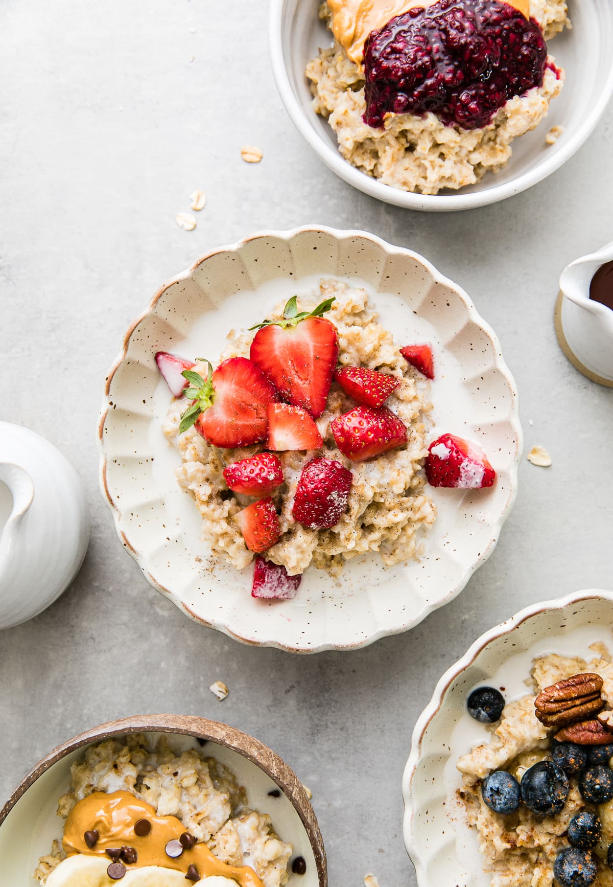 top down view of bowl of healthy oatmeal with strawberries and cream.