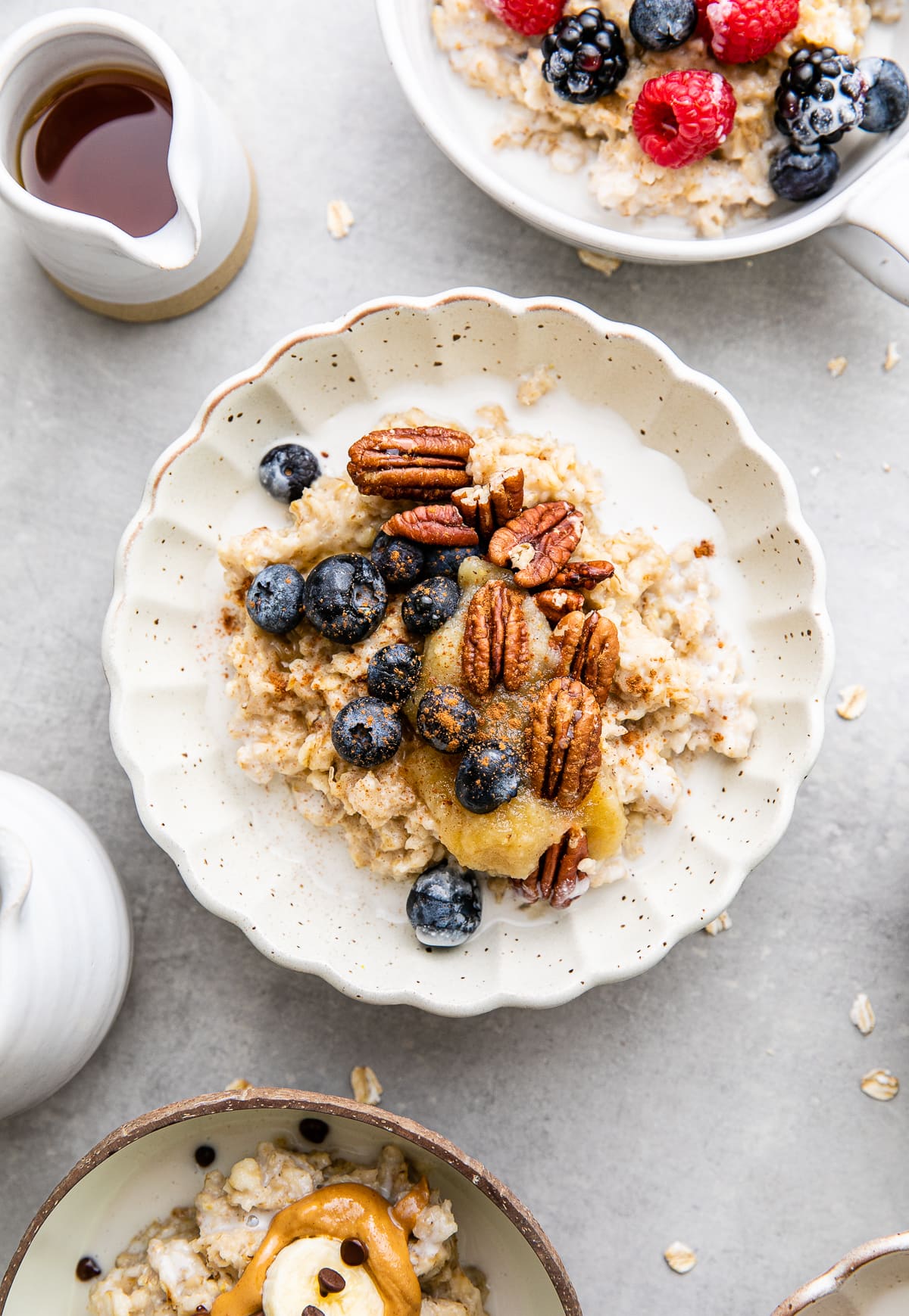 top down view of healthy oatmeal in a bowl topped with blueberries, pecans and applesauce.