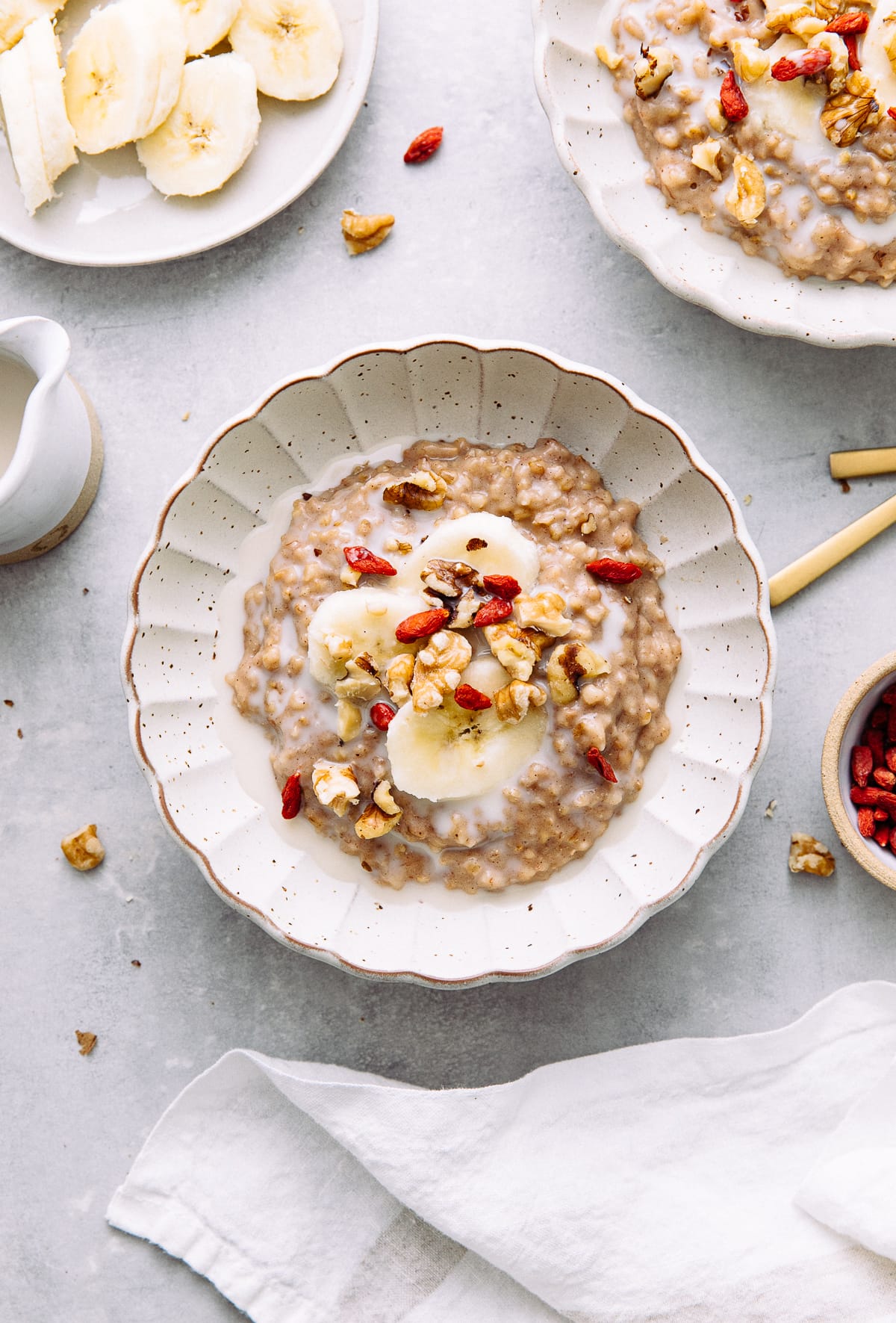 top down view of bowl with banana overnight steel cut oats with items surrounding.