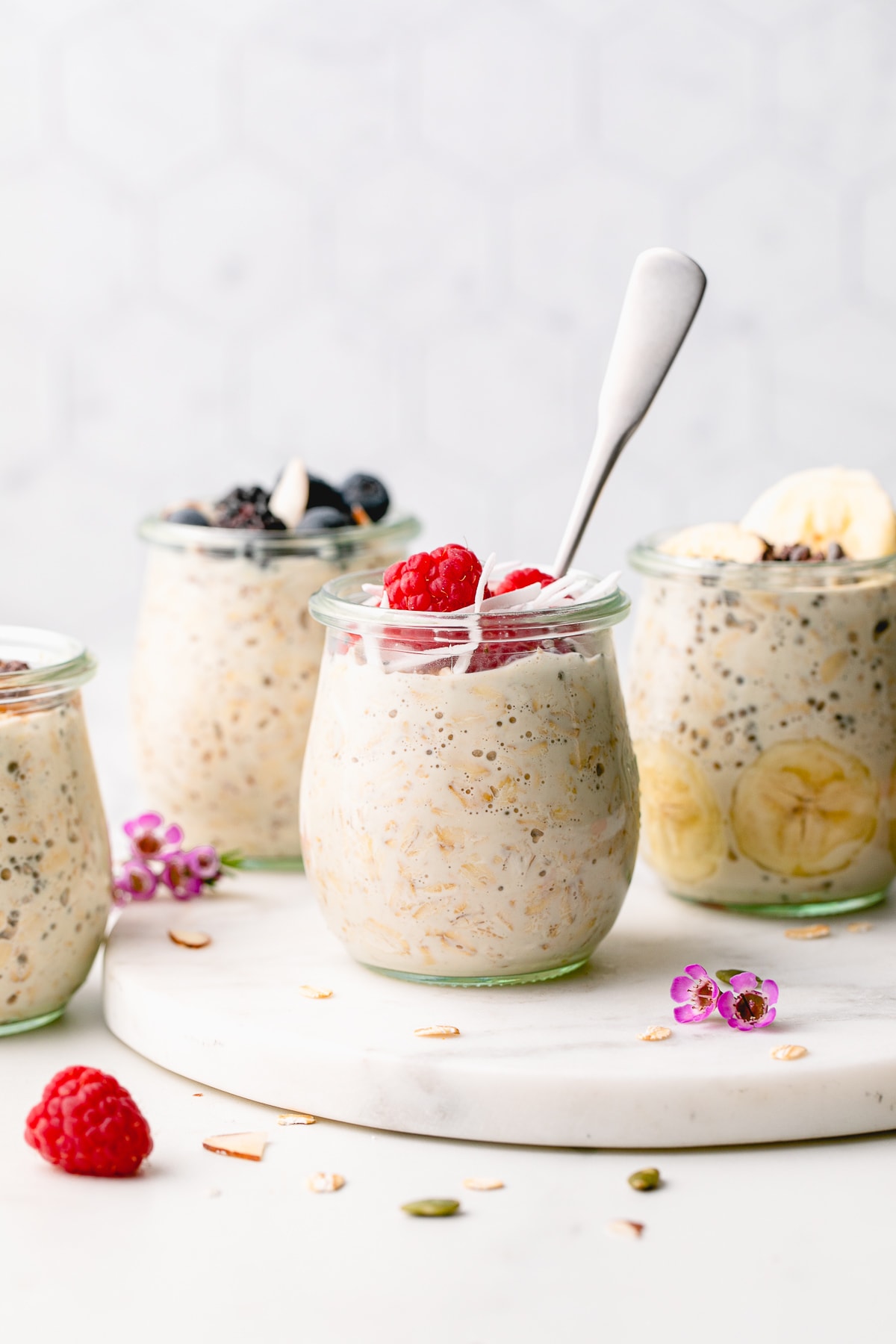 head on view of a group of mason jars with overnight oats with toppings.