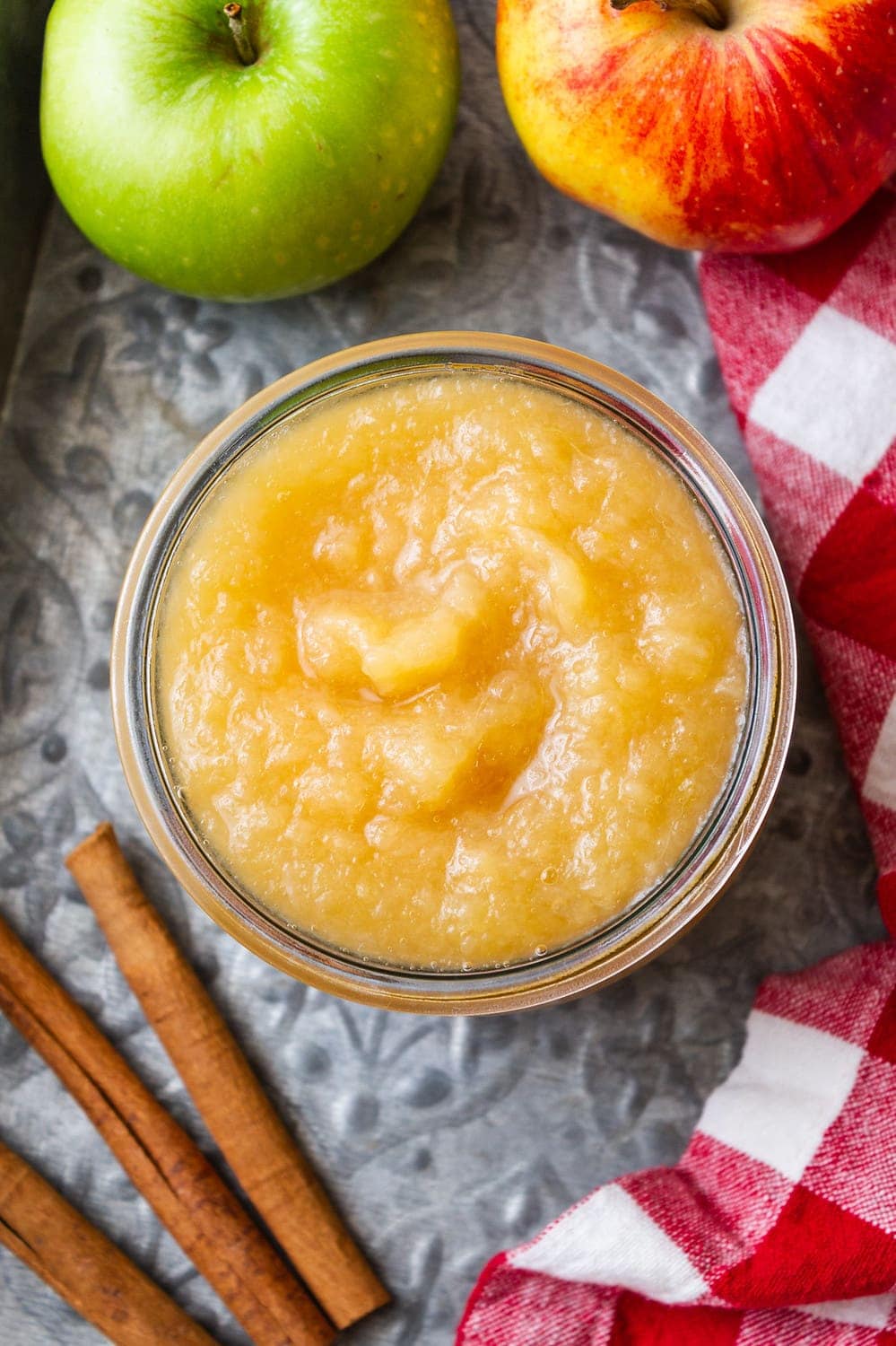 top down view of a glass jar filled with homemade applesauce