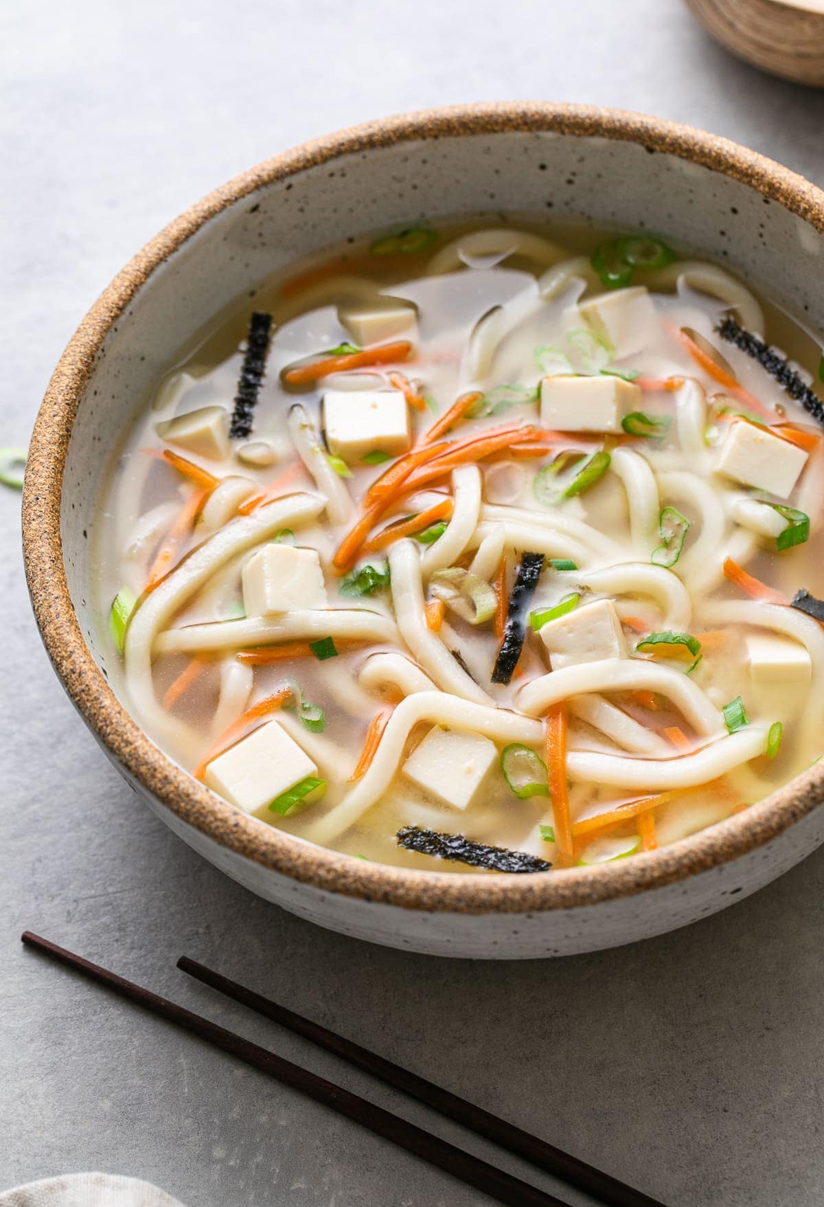 side angle view of bowl of miso noodle soup with tofu.