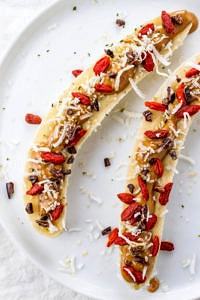 top down view of banana boats on a white plate.