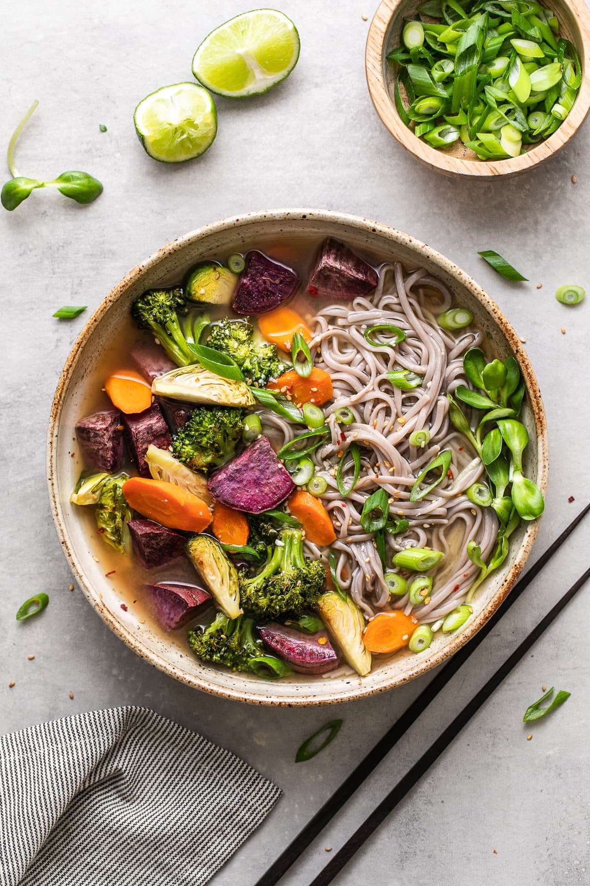 top down view of bowl with serving of soba miso soup with vegetables and items surrounding.