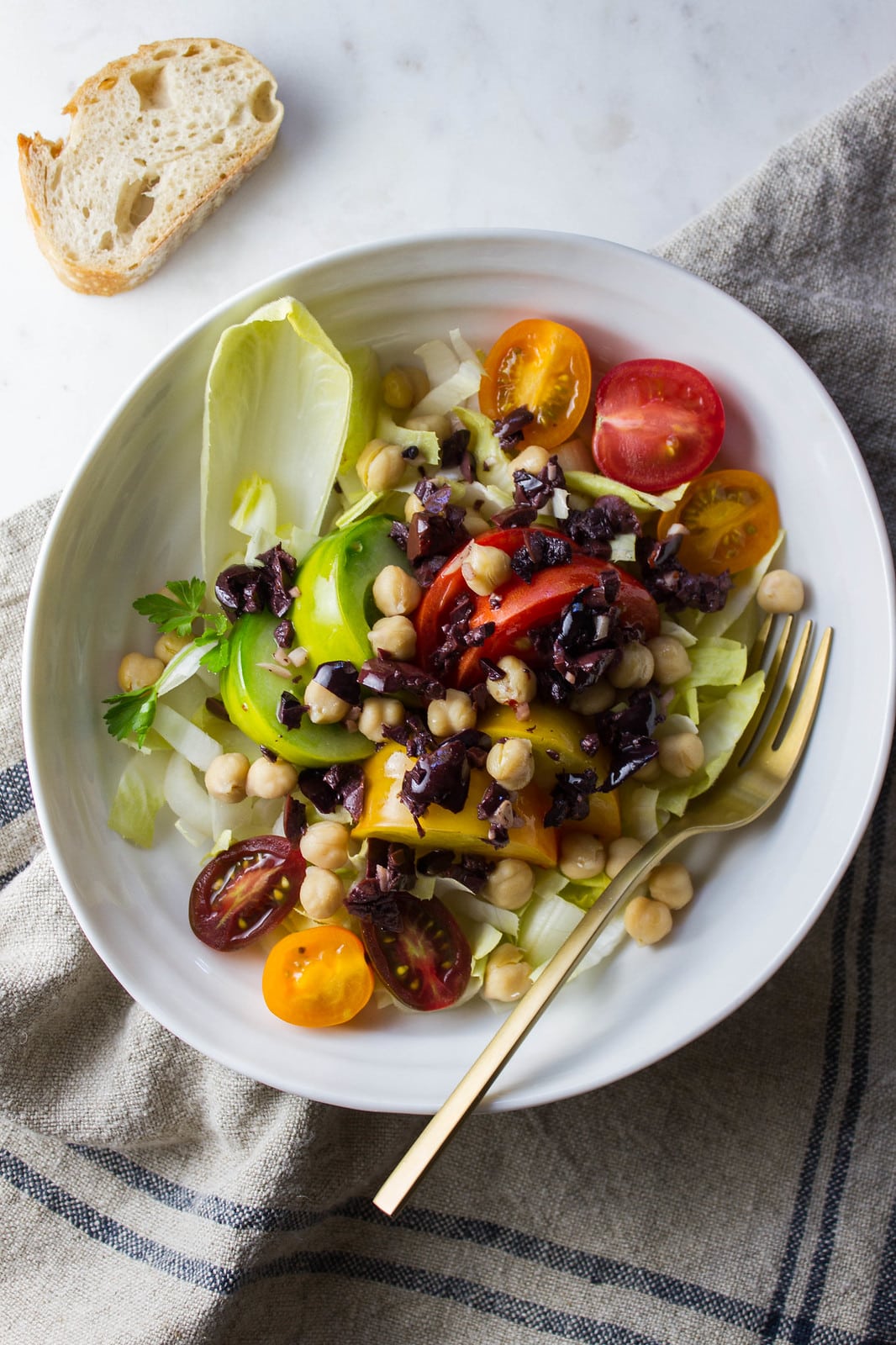 top down view of plated tomato endive salad with olive bagna cauda