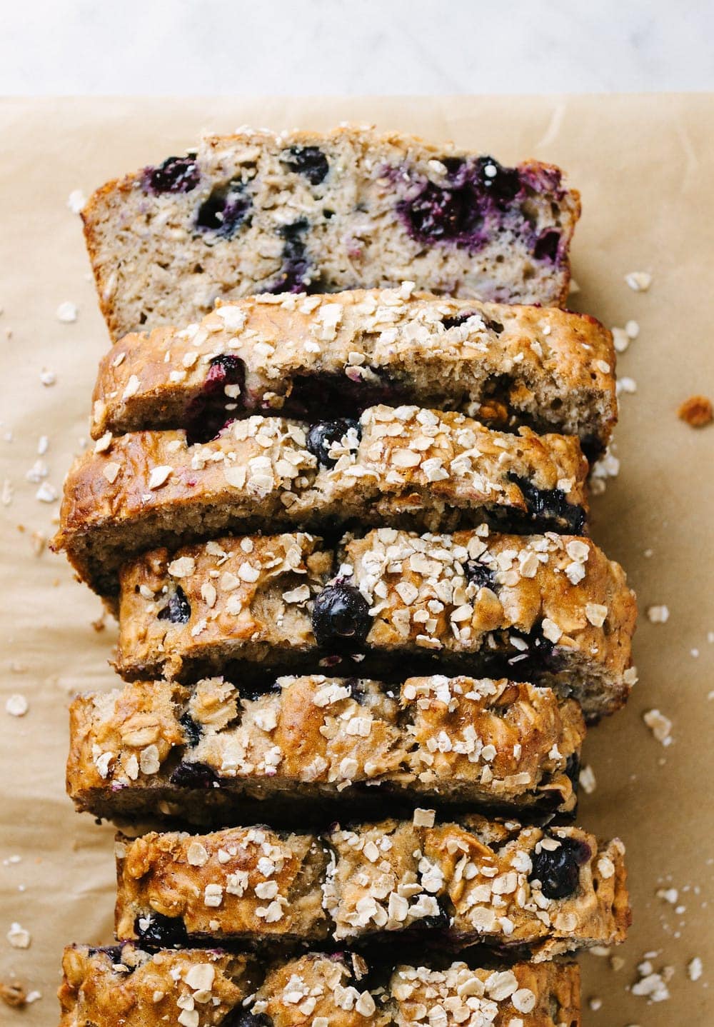 top down view of vegan blueberry banana oat bread cut into slices