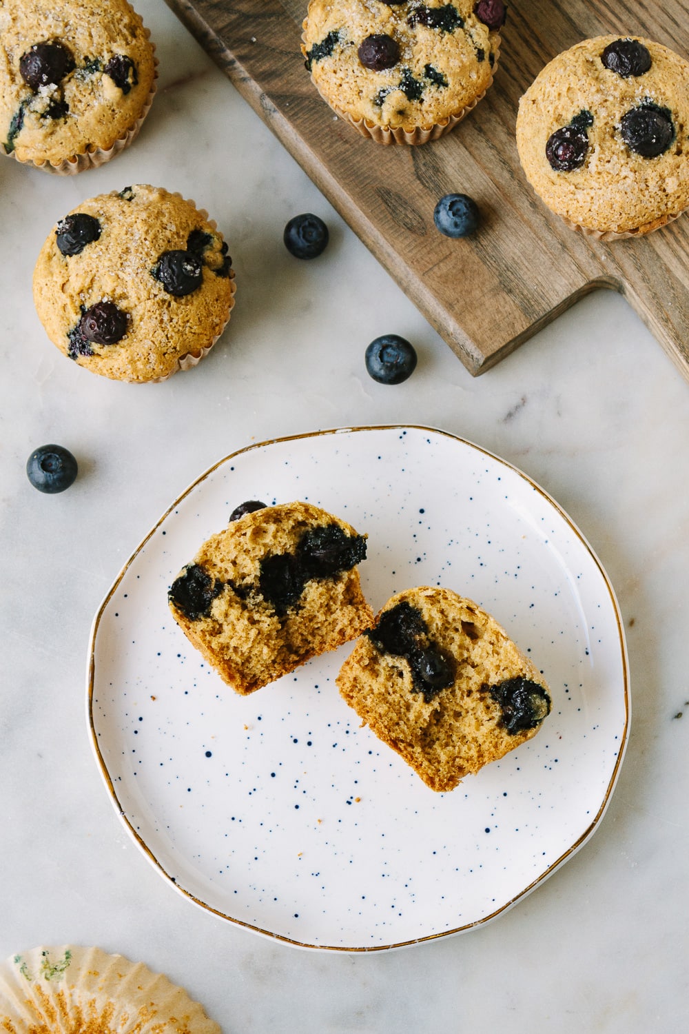 top down view of a healthy vegan muffin split in half on a small plate.