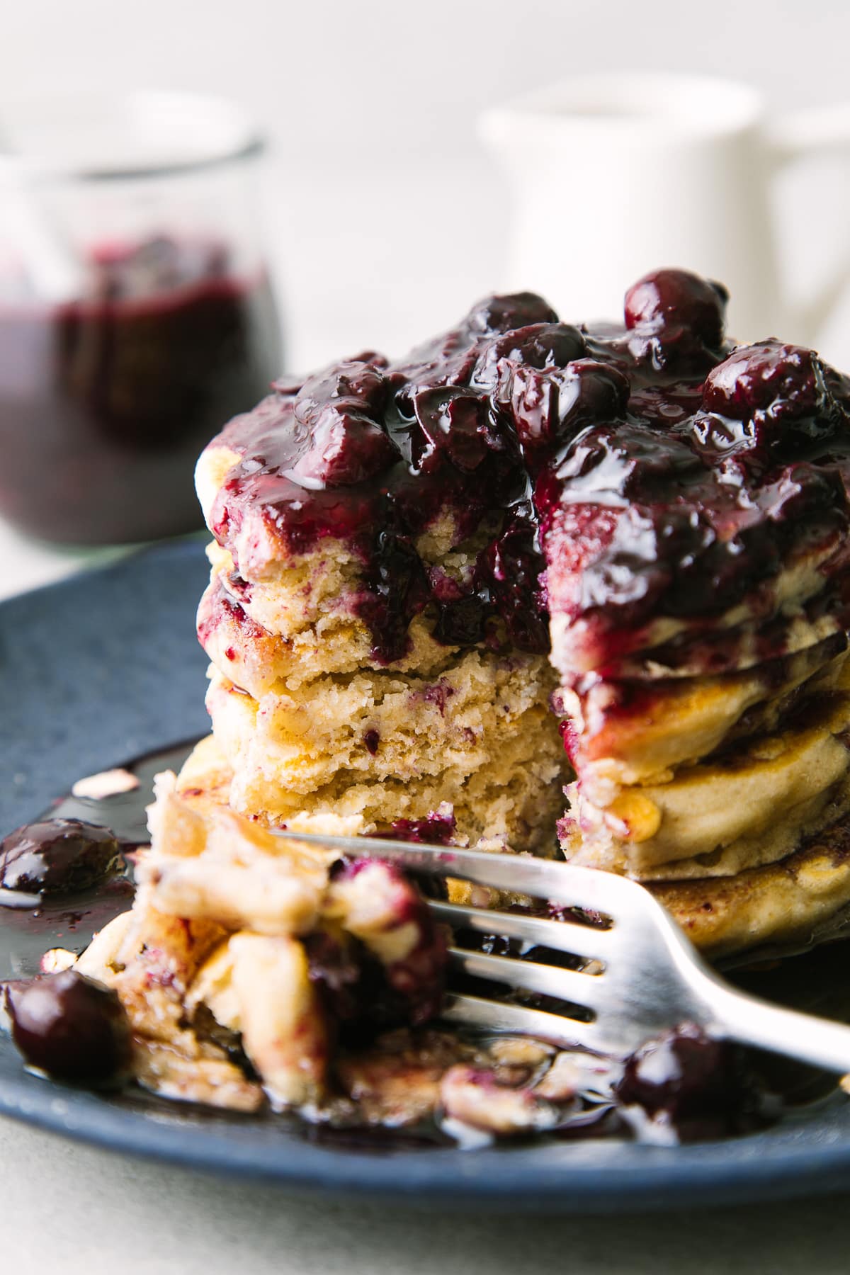 head on view of vegan oatmeal pancakes cut showing the fluffy middle.