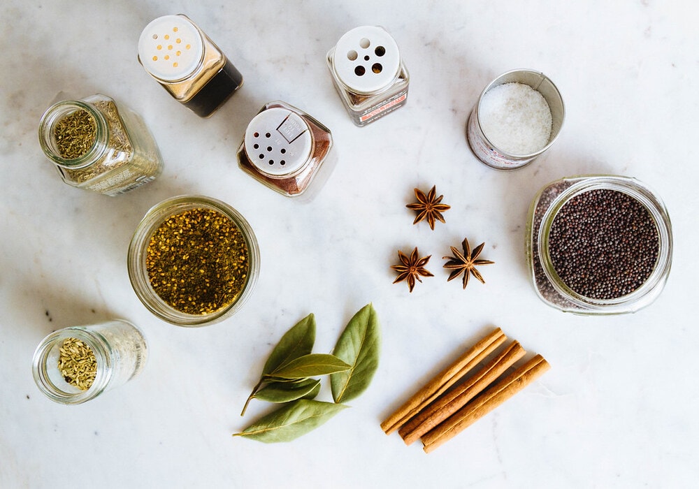 a variety of spices on a marble slab.