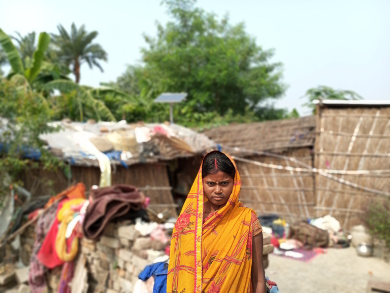 A snake bite survivor stands outside.